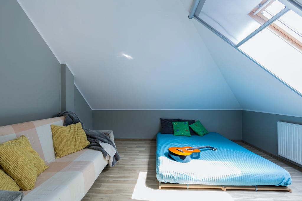Attic minimalist bedroom with mattress