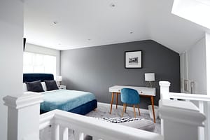 Interior of a house, loft conversion bedroom seen across stair banister in Gotham