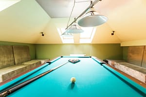 Entertainment attic room with a pool table in Lees